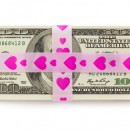 © 18042011e | Dreamstime.com - Stack Of Money Tied Up By Pink Ribbon With Hearts Photo