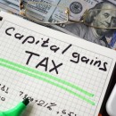 © Designer491 | Dreamstime.com - Notebook With Capital Gains Tax Sign On A Table. Photo