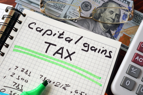 © Designer491 | Dreamstime.com - Notebook With Capital Gains Tax Sign On A Table. Photo