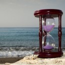 © Gorshkov13 | Dreamstime.com - Hourglass On Sandy Marine Beach Photo
