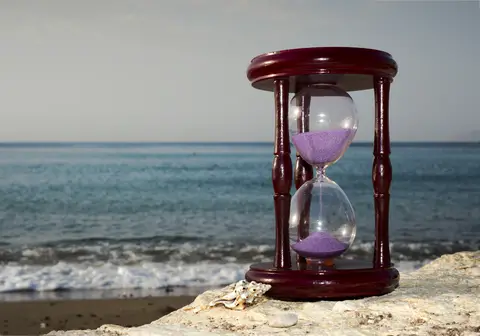 © Gorshkov13 | Dreamstime.com - Hourglass On Sandy Marine Beach Photo