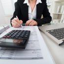 © Andreypopov | Dreamstime.com - Businesswoman Calculating Invoice Photo